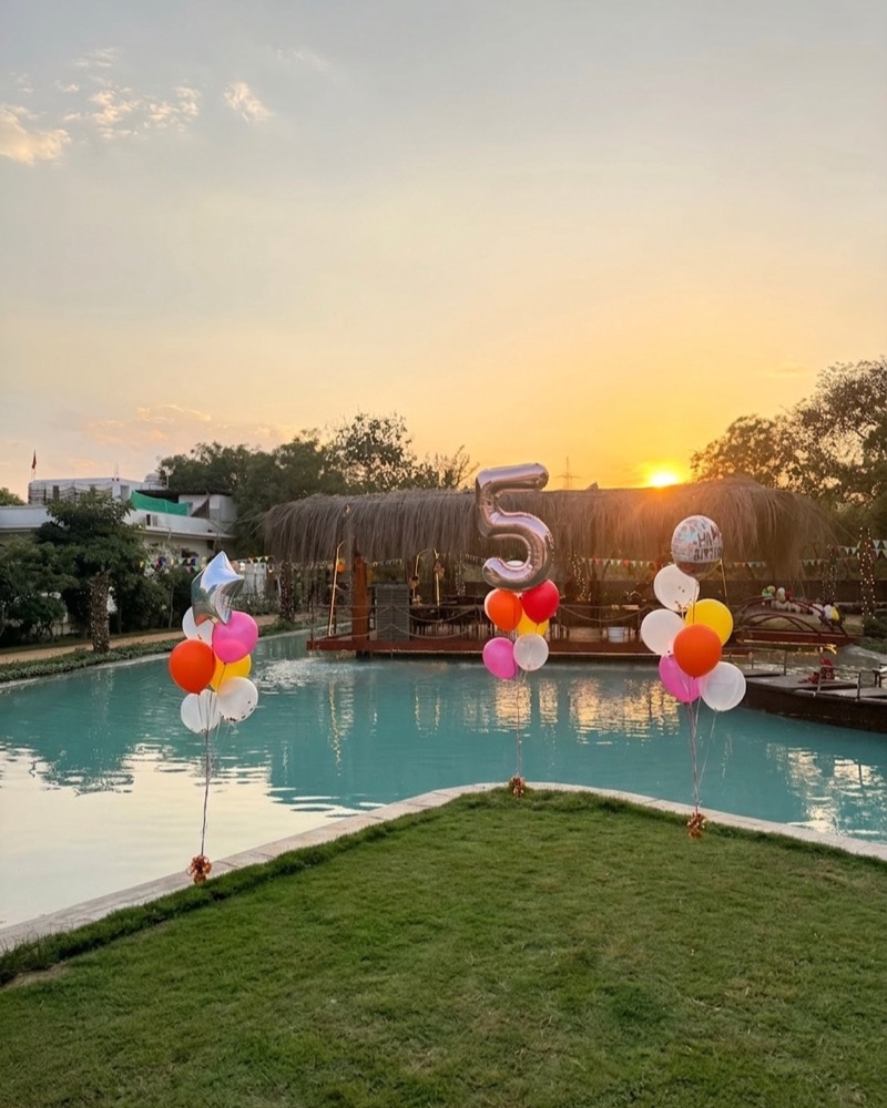 Balloons by the pond at golden hour, set for a birthday